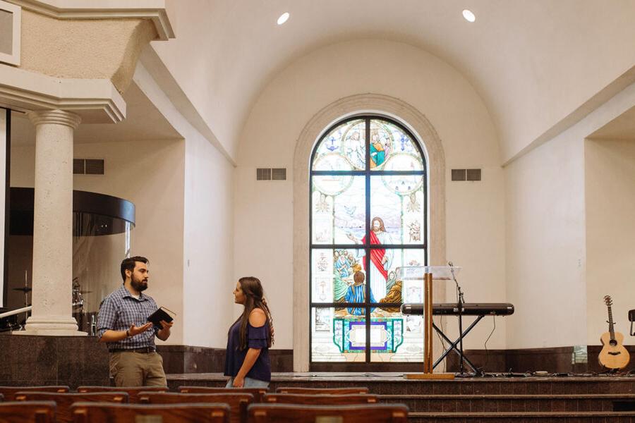 ministry student in the chapel providing counsel to another student